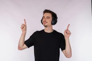 Portrait of happy young man wearing headphone and enjoy music over white background photo