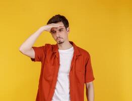 Portrait of thinking man surrounded by question mark on isolated background photo