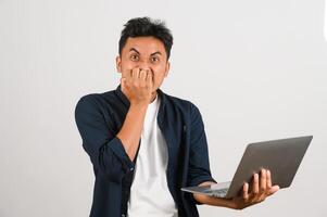 Portrait of a happy asian businessman working on laptop computer isolated over white background photo