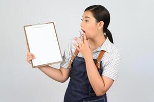 Portrait of young asian woman in waitress uniform pose with clipboard photo