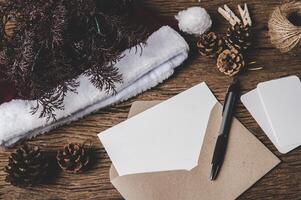 envelope of paper lying among small decorations on wooden desk. photo