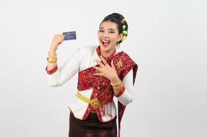 Young beautiful woman in northeastern dress show credit card posture photo