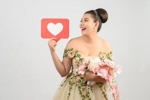 Asian beautiful bride smiling and posing with heart sign on white background photo