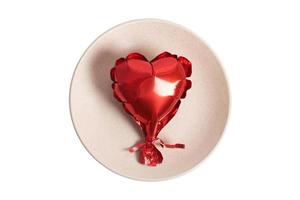 1005 Beige plate and red heart balloon isolated on a transparent background photo