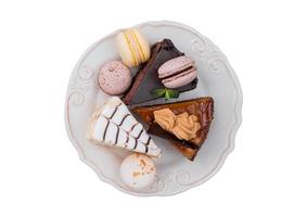 2550 White plate with three differents types of desserts isolate on a transparent background photo