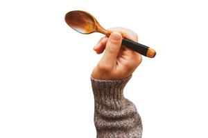 285 Hand holding a wooden spoon isolated on a transparent background photo