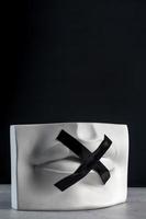 Silence sign. Plaster statue of lips with black tape. Keep quiet. photo