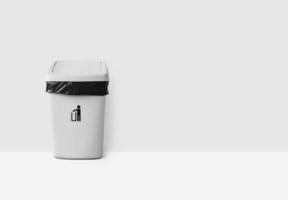 White trash can with lid on white background photo