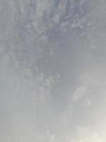 Beautiful white clouds on deep blue sky background. Large bright soft fluffy clouds are cover the entire blue sky. photo