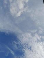 Beautiful white clouds on deep blue sky background. Large bright soft fluffy clouds are cover the entire blue sky. photo