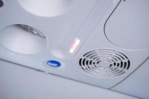 View of air conditioner console panel on board of an aircraft,airplane cabin with no smoking sign on photo