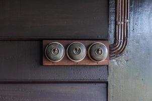 Vintage put light switch on wooden interior wall photo