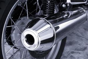 Modern big chromed exhaust on motorcycle photo