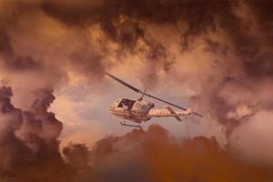 A Rescue Helicopter races against an oncoming Storm severe weather,Modern attack helicopter with with weapons photo