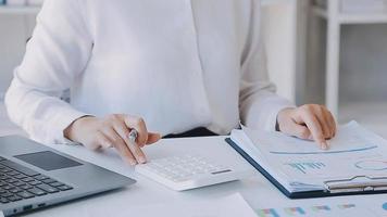 Financial analysts analyze business financial reports on a digital tablet planning investment project during a discussion at a meeting of corporate showing the results of their successful teamwork. video