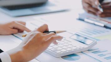 Financial analysts analyze business financial reports on a digital tablet planning investment project during a discussion at a meeting of corporate showing the results of their successful teamwork. video