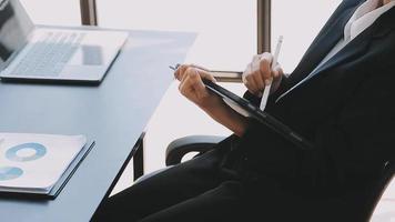 Financial analysts analyze business financial reports on a digital tablet planning investment project during a discussion at a meeting of corporate showing the results of their successful teamwork. video