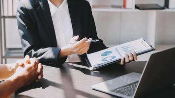 Financial analysts analyze business financial reports on a digital tablet planning investment project during a discussion at a meeting of corporate showing the results of their successful teamwork. video