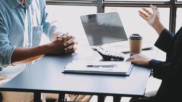 Financial analysts analyze business financial reports on a digital tablet planning investment project during a discussion at a meeting of corporate showing the results of their successful teamwork. video