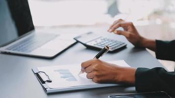 Financial analysts analyze business financial reports on a digital tablet planning investment project during a discussion at a meeting of corporate showing the results of their successful teamwork. video