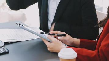 Financial analysts analyze business financial reports on a digital tablet planning investment project during a discussion at a meeting of corporate showing the results of their successful teamwork. video