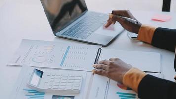 Financial analysts analyze business financial reports on a digital tablet planning investment project during a discussion at a meeting of corporate showing the results of their successful teamwork. video