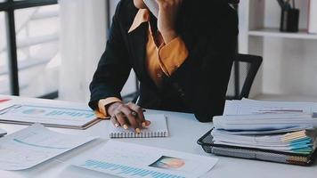 Financial analysts analyze business financial reports on a digital tablet planning investment project during a discussion at a meeting of corporate showing the results of their successful teamwork. video