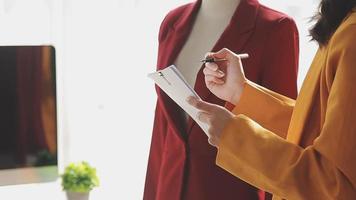 Diverse female fashion designers at work with tailor centimeters on necks and holds tablet and notepad. independent creative design business. video