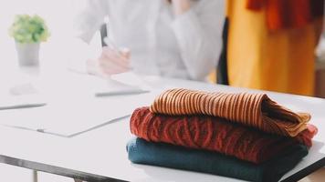 Diverse female fashion designers at work with tailor centimeters on necks and holds tablet and laptop. independent creative design business. video