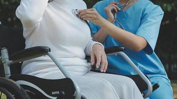 young asian physical therapist working with senior woman on walking with a walker video