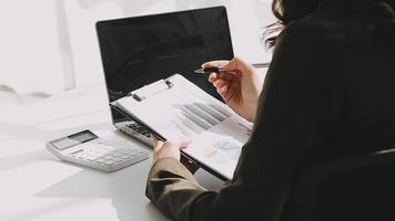 Financial analysts analyze business financial reports on a digital tablet planning investment project during a discussion at a meeting of corporate showing the results of their successful teamwork. video