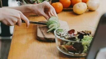 Jeune et content femme en mangeant en bonne santé salade séance sur le table avec vert Frais Ingrédients à l'intérieur video