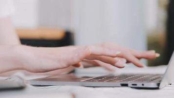 Asian Business woman using calculator and laptop for doing math finance on an office desk, tax, report, accounting, statistics, and analytical research concept video