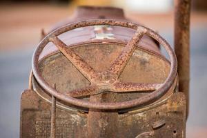 Old rusted antique tractor steering wheel detail photo