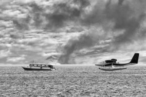 maldives floatplane and boat at the sea landscape view photo