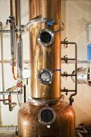 Copper still alembic inside distillery photo