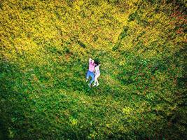 happy couple in love laying on the field on summer day. top view. Intimacy and healthy relationship concept photo