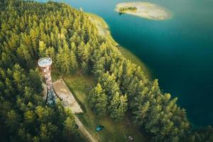 Labanoras - watch tower from aerial perspective with lake in the background. Square image of a countryside of Lithuania. Labanoras regional park observation. photo