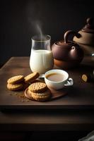 tetera, té con leche y galletas foto