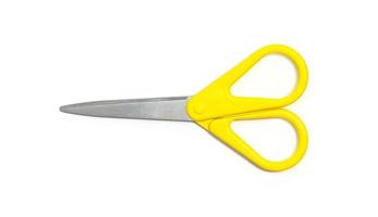 Yellow scissors isolated on white background. photo