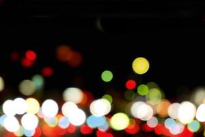 Abstract colorful bokeh and blurred reflection lighting on black background photo