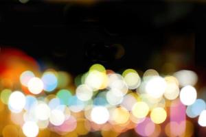 Abstract colorful bokeh and blurred reflection lighting on black background photo