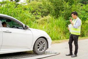 An insurance agent is using a radio communication to talk about a car crash., Accident, crash or collision of auto car, photo