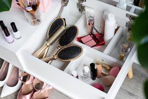 closeup of elegant high heel shoes standing under feminine dressing table photo