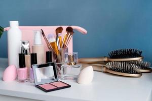 closeup of feminine cosmetic products standing on dressing table photo