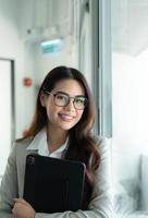 Portrait of Business female rookie in the new entrepreneurial with a tablet as a tool to help in the work photo