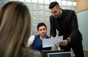 New business people in the conference room are exchanging information with each other along with rehearsing important information photo