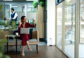 Portrait of Business female rookie in the new entrepreneurial with a laptop as a tool to help in the work photo