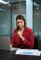 Young woman working at a call center which is a consultant for various information of customers who call to inquire or ask for advice photo