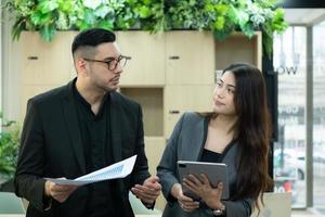 Boss and secretary Reviewing the schedule and tasks to be considered today. In the morning of the new day in the office break room photo